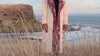 Nora Silk Road Jacquard Coat in a coastal cliff setting - Nastaran